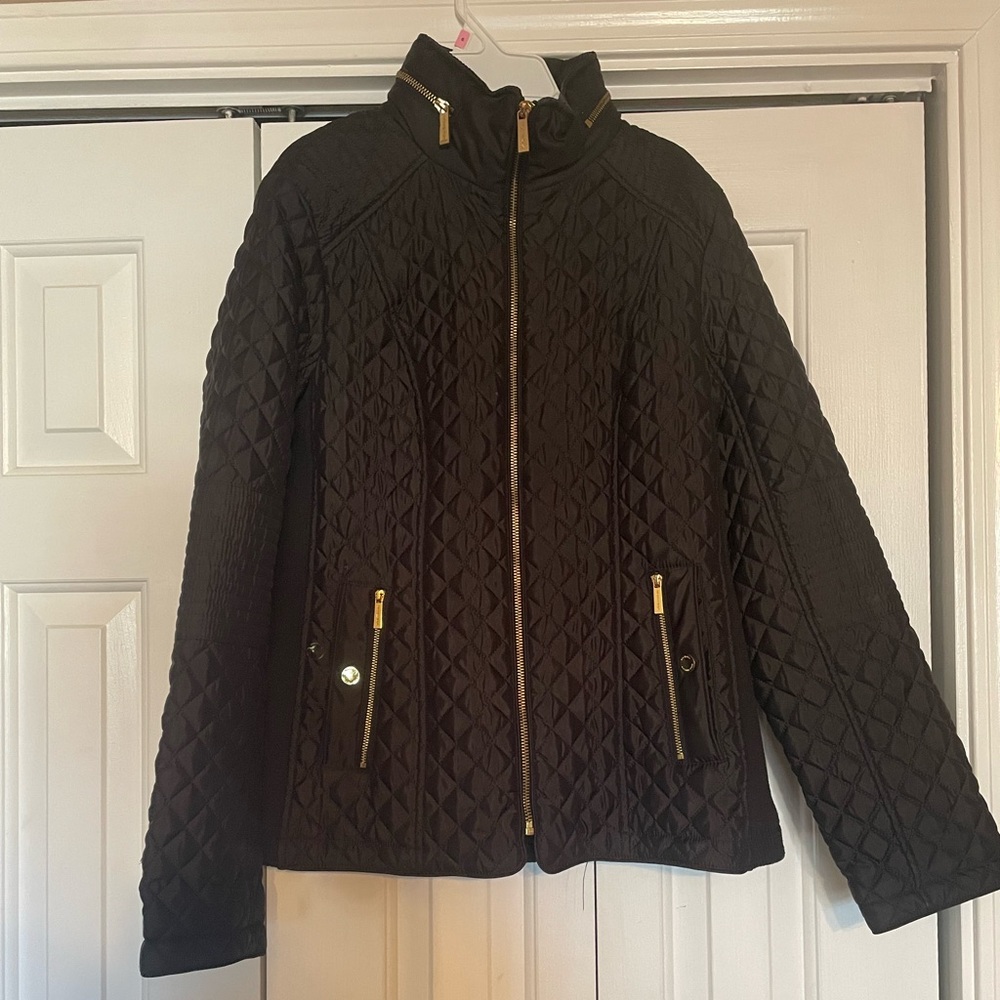 Micheal Kors black zip up jacket with zipper pockets in the front.
